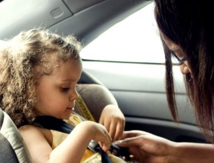 donna assicura figlia al seggiolino