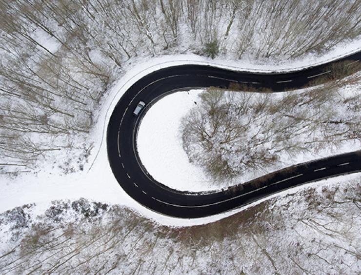 une vue aérienne d'une route sinueuse dans la neige